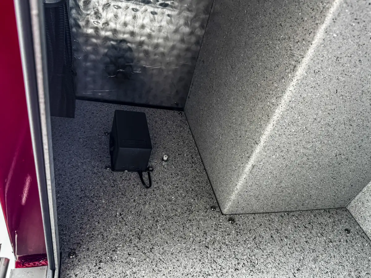 Side body detail with intake connection and polished panel hardware.